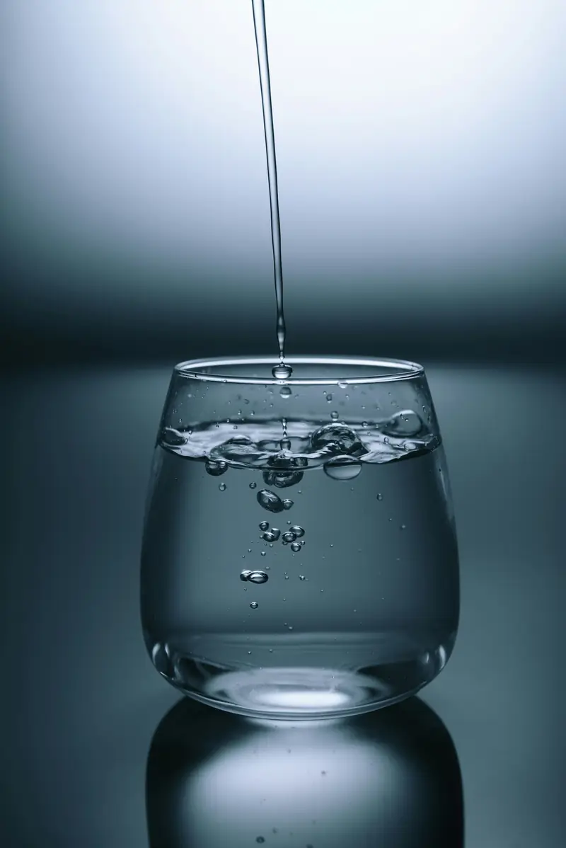 Pure filtered drinking water from a Jalsudha RO plant poured into a glass